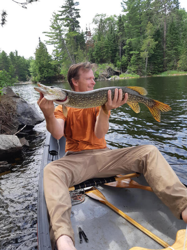Blair holding his largest pike to date while fishing from our canoe
